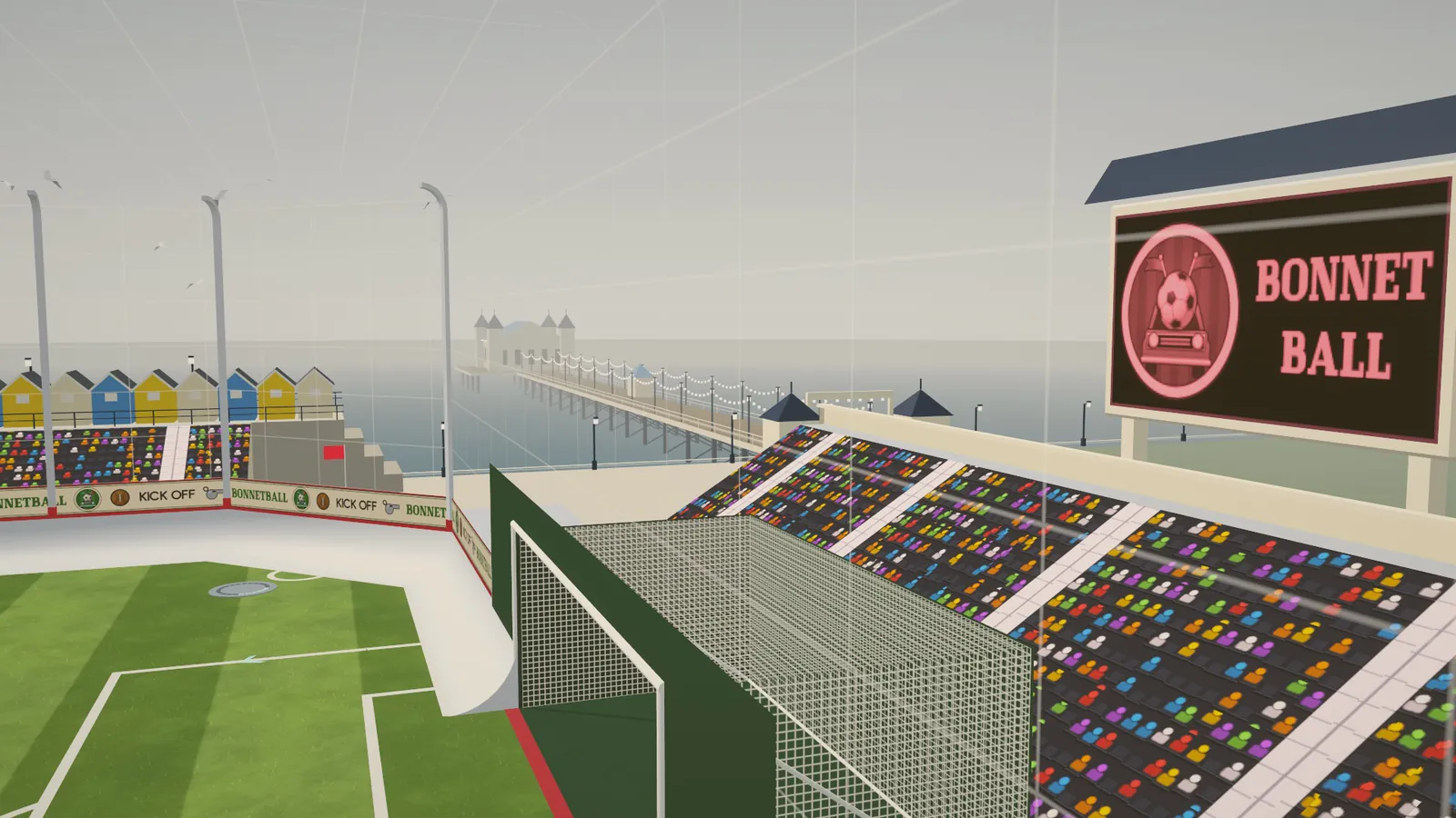Past the goal at U-TURN PARK towards the pier, its lamp strings and pier-head pavilion, with beach huts on the left
